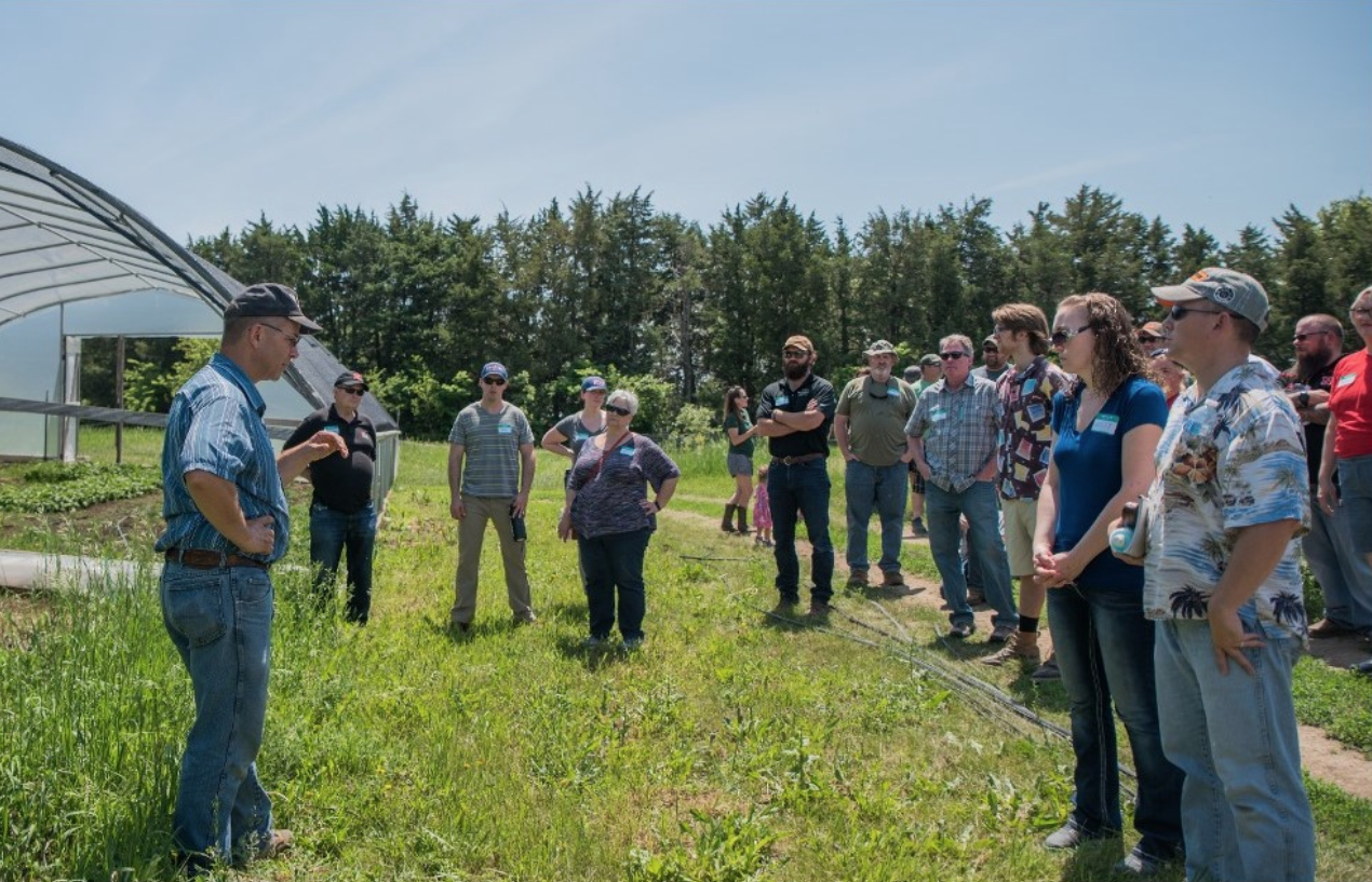 veterans learning about farming practices on a local farm