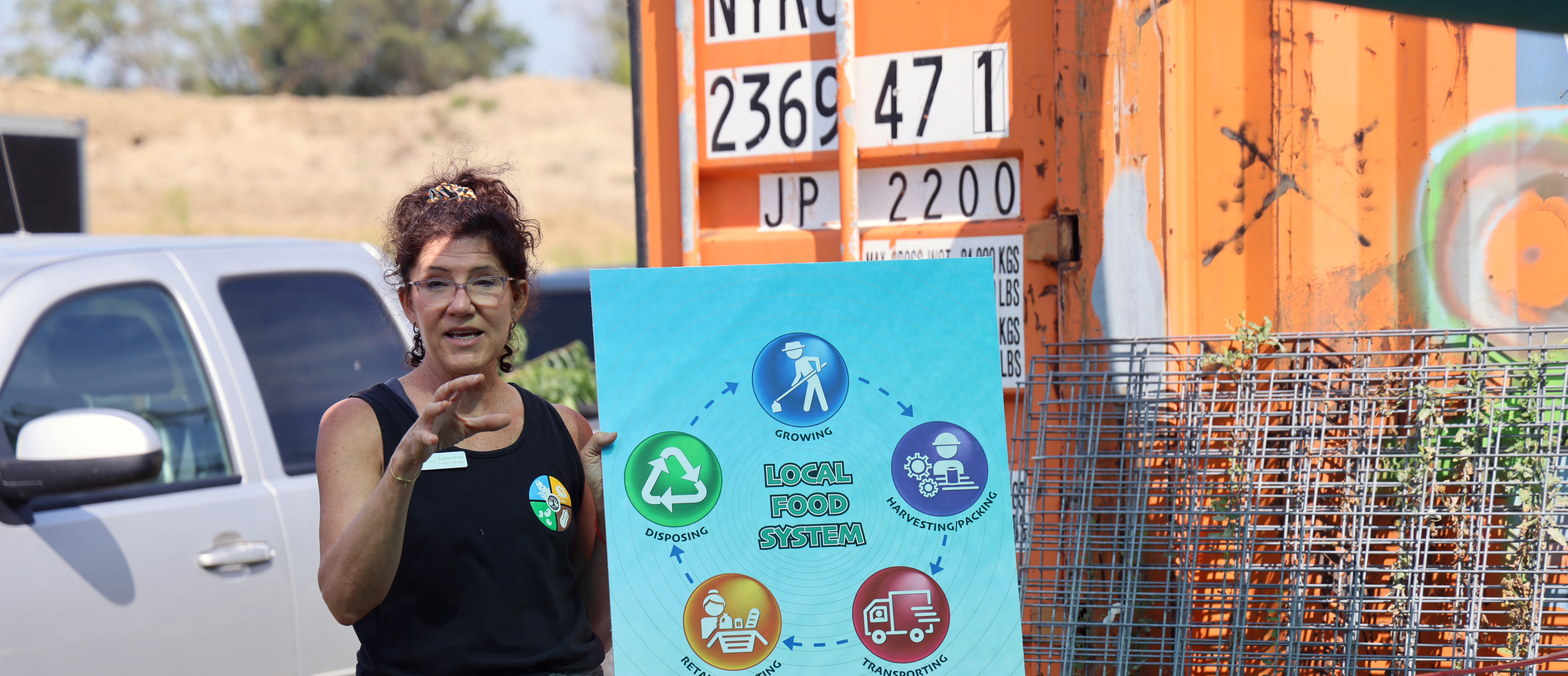 A woman presents on food systems at an urban farm. Photo by Russell Shaffer