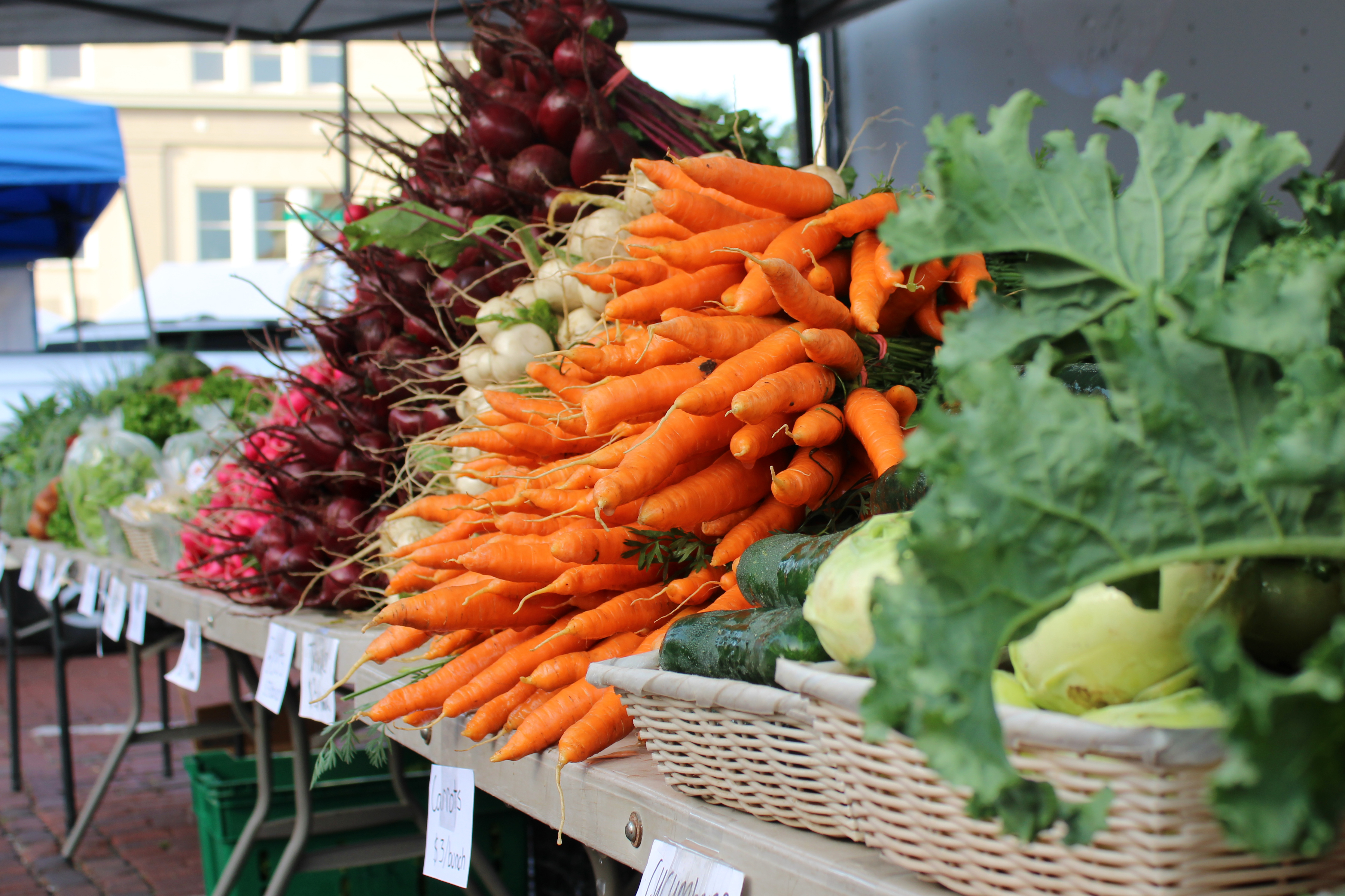 Vegetables at a stand at a farmers market.