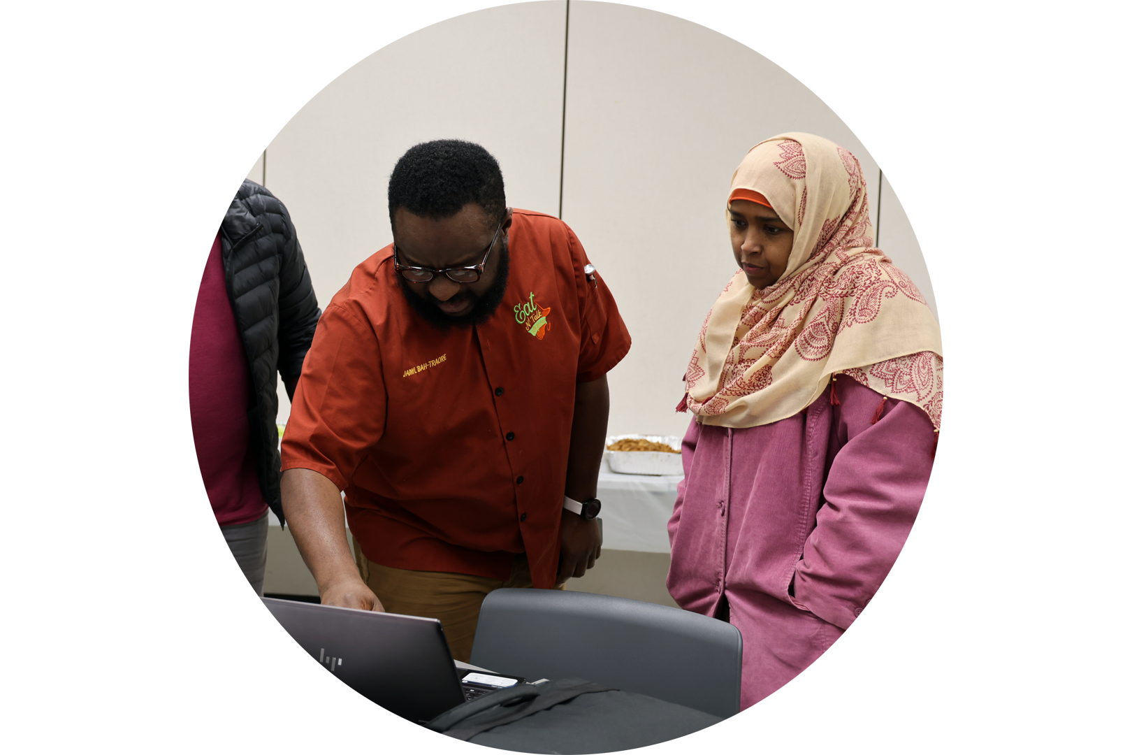 Attendees at a Nebraska Extension international food event look at a laptop. Photo by Russell Shaffer