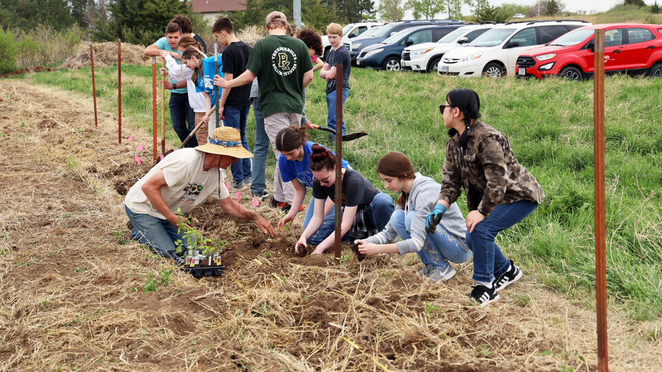 Students plant crops at a farm. Photo by Russell Shaffer