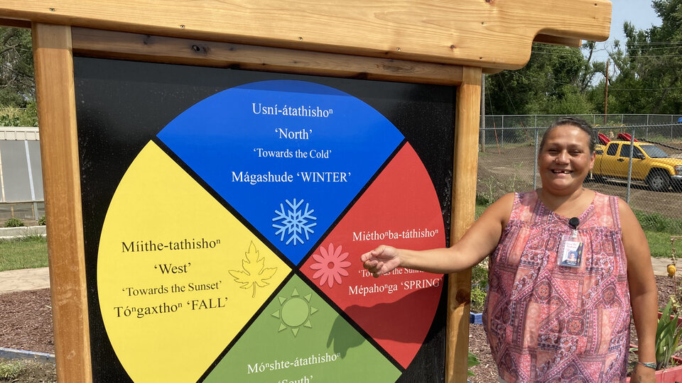 A woman points to the medicine wheel cycle.