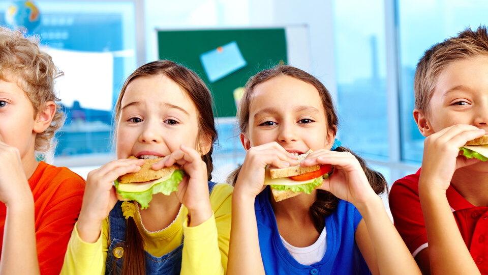 Kids eating sandwiches.