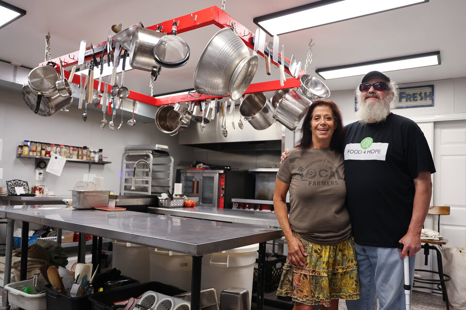 Terri Sue Mazza and her husband stand in the industrial kitchen at Food4Hope in Beatrice, Neb.